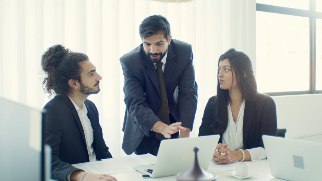 pexels photo 8463135 8463135 Professional team in office discussing a business project with focused collaboration.