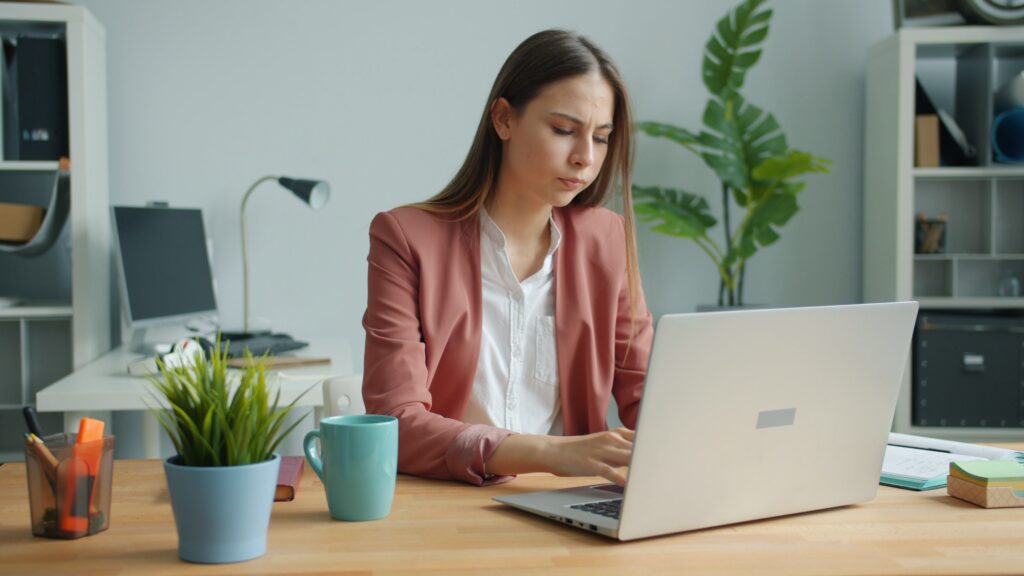 pexels photo 36713175 36713175 Focused young woman working at a laptop in a stylish, modern office setting.