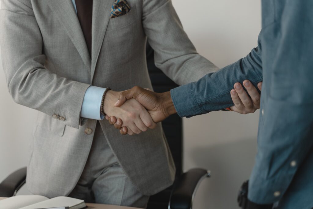 pexels photo 5439470 5439470 Image of a professional handshake between two businessmen in an office setting.