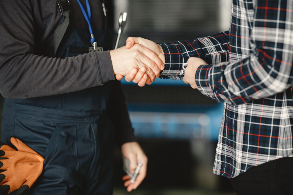 pexels photo 6720535 6720535 Close-up of a handshake between workers in a workshop, symbolizing business agreement and teamwork.